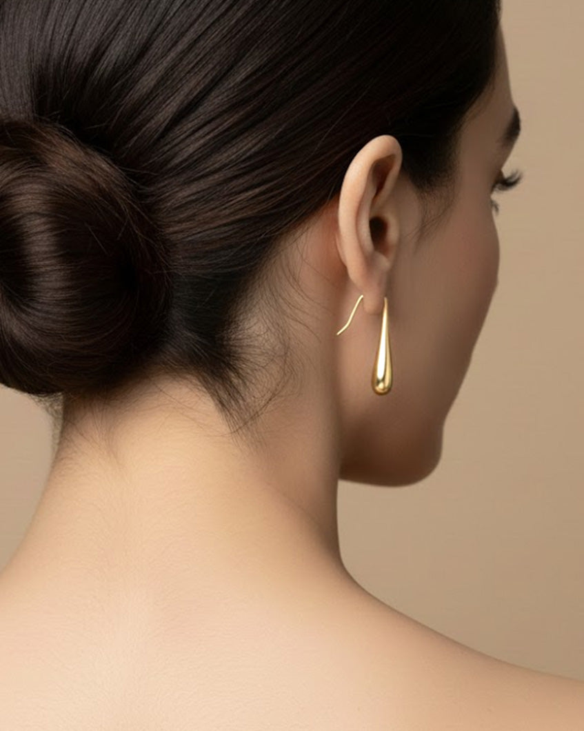 Ease In Earrings - Fluid gold curve hoop earrings, crafted from lightweight, anti-tarnish, and hypoallergenic 18K gold plating for everyday comfort.